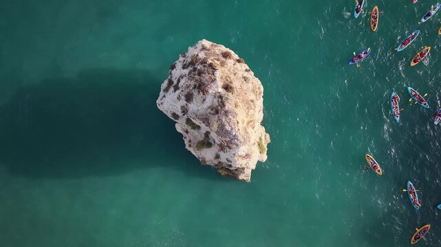 Kayakers exploring marinha beach rock formations in portugal