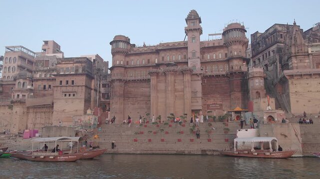 Varanasi, India - 06 September 2026: View of the historic Chet Singh Ghat with stone architecture and wooden boats on the Ganges river.