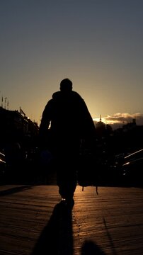 silhouette of a man on a bridge