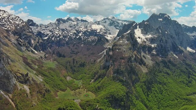 Aerial view of amazing rocky mountains in snow, Prokletie park, Montenegro and Albania, 4k