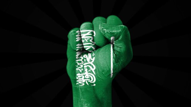 Saudi Arabia flag painted on clenched fist in front of black background 4k footage close up