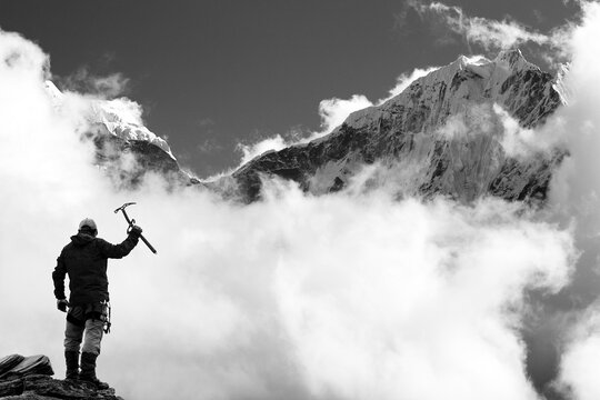 Himalayas mountains and climber with ice axe in hand