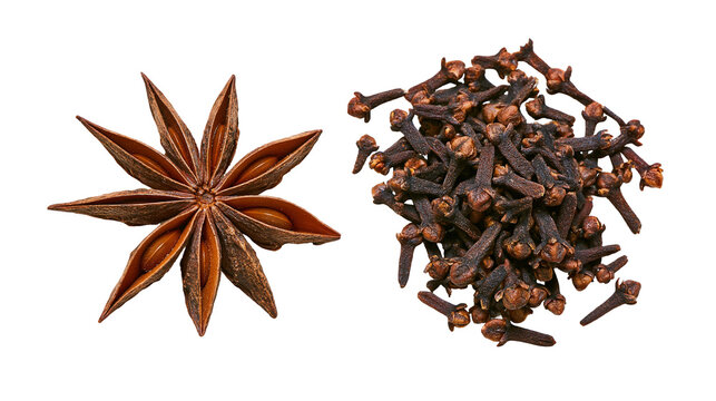 Isolated. Star anise spice and a pile of whole dry cloves. Aromatic brown seasoning ingredients.