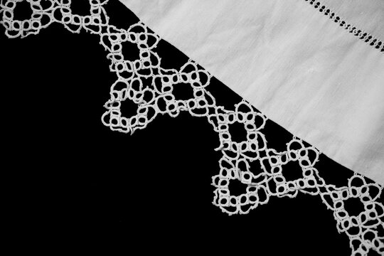 Antique Tatting lace frivolite decor border isolated on black background, top view, handmade, vintage textile design, old fabric art, needlework, homespun tablecloth