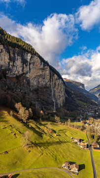 Drone aerial view of famous Staubbach Falls plunging from vertical rock cliff in Lauterbrunnen Switzerland