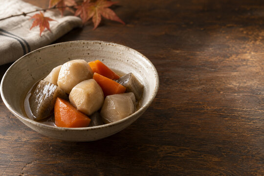 Japanese simmered taro and konnyaku in warm autumn light