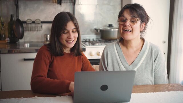 Young Latina woman teaching computer skills to adults at home, representing digital literacy, technology education, professional training, and intergenerational learning.
