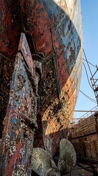 Rusty ship hull and propeller in dry dock