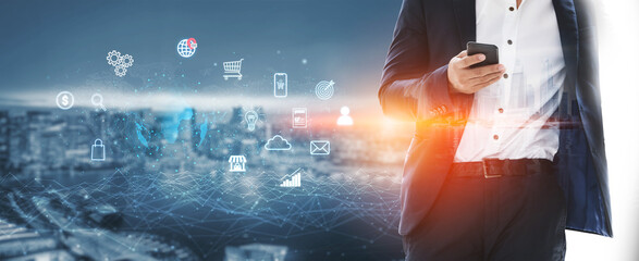 Business Person Using Smartphone with Digital Icons Overlaid on Cityscape Representing Technology...