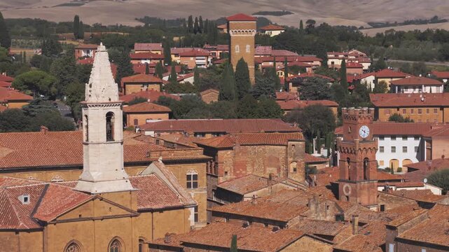 Aerial view of the historic town of Pienza with terracotta rooftops, stone buildings, and church towers in Pienza, Tuscany, Italy.