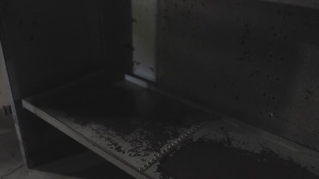 A grim, low-light shot inside an empty prison cell, focusing on stark steel bunk beds against cold, gray concrete walls. The dark and institutional atmosphere evokes feelings of isolation, confinement
