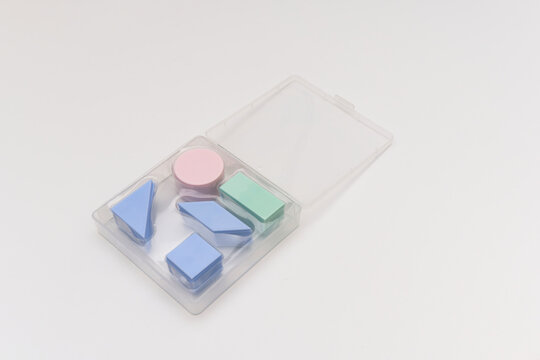 Geometric Shapes in Plastic Box on White Background