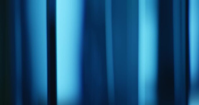 Radiant blue lights illuminate the brilliance of moving reflective glass creating a gradient of soft blues for a calm, relaxing aura. Smooth dreamy blue lighting abstract background or wallpaper Loop