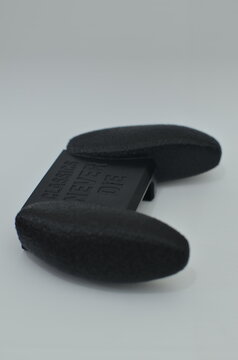 Black 3D printed gaming grip with embossed classics never die text