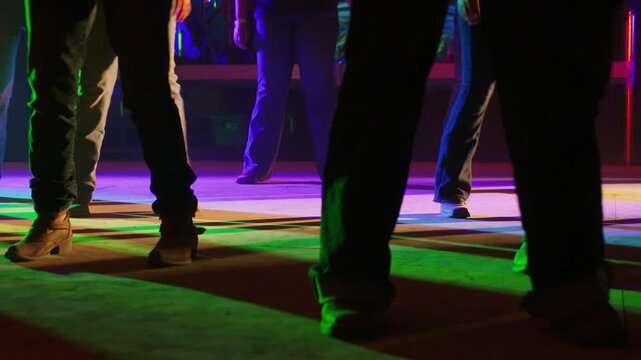 Boots Dancing to Country Music Under Colorful Stage Lights