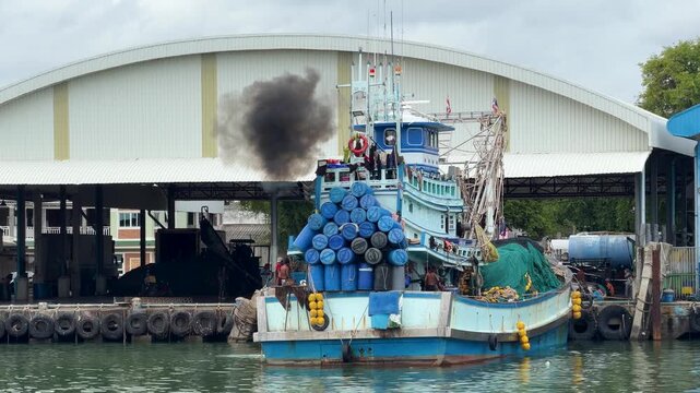 Fishing Trawler Emitting Thick Black Smoke Exhaust at Harbor Dock