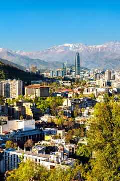 Panoramic view of the Santiago skyline featuring modern skyscrapers and the snow-capped Andes mountains in Chile, captured from Santa Lucia Hill.
