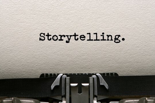 Storytelling typed on white paper with an antique typewriter for creative writing literature and narrative author