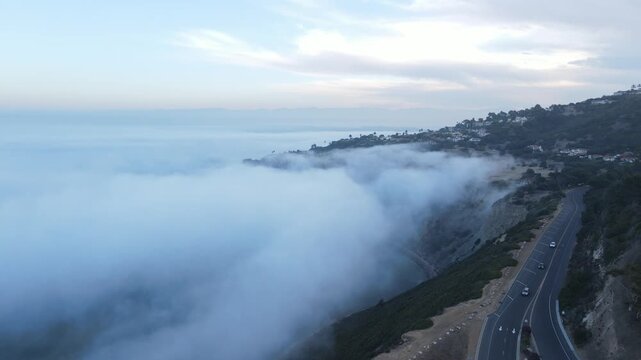 Descending from above the marine layer to a coastal road overlook