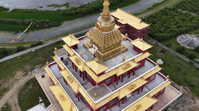 Aerial orbit around a golden tiered stupa on the Tibetan plateau