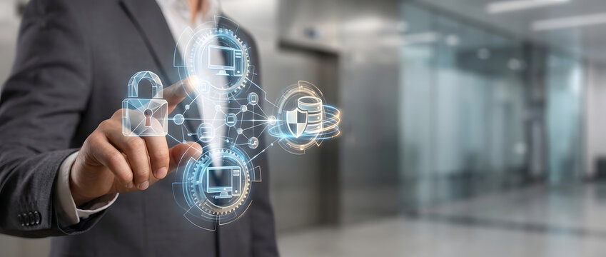 Businessman interacting with a futuristic digital interface showing cyber security icons, data protection concepts, encrypted network connection, and cloud server safety in a modern office.