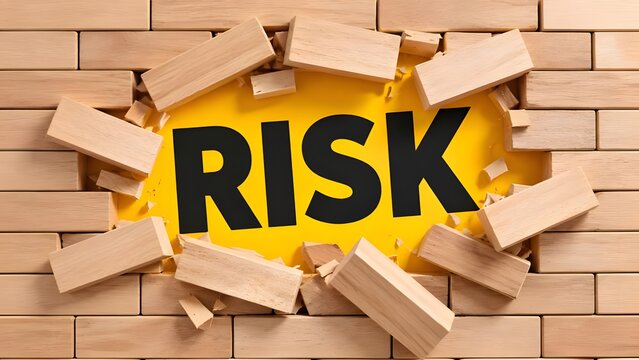 Concept of breaking through barriers revealing the word risk on yellow background representing business challenges and danger