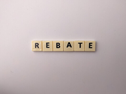 Beige letter tiles spell out the word REBATE horizontally aligned on a smooth white background