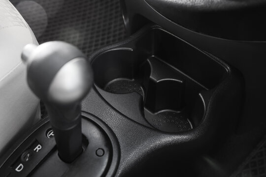 Automotive convenience and car interior design, empty cup holders and gear shift lever in a modern vehicle for travel and commuting comfort