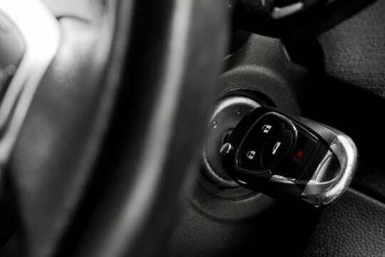 Car ignition and vehicle security, driver starting engine with modern key fob in dashboard for transportation and automotive travel safety