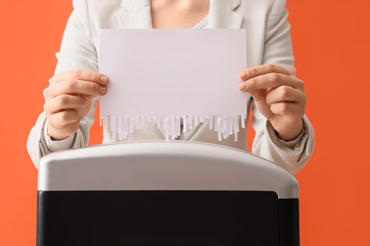 Data privacy and document security, business person shredding confidential paper with sensitive information for identity theft protection and compliance