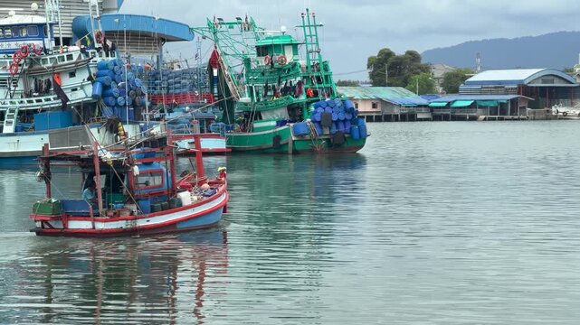 Colorful Wooden Fishing Boat Navigating Through a Harbor