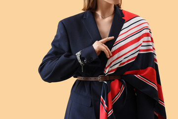 Personal style and fashion trends, woman wearing a navy blue blazer with a striped scarf and...