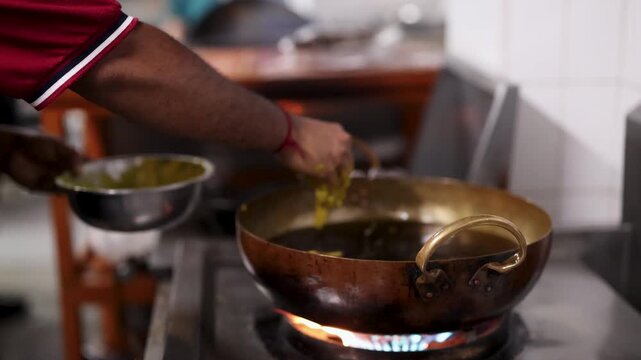 Chef Deep Frying Food in Hot Oil Using Traditional Kadai