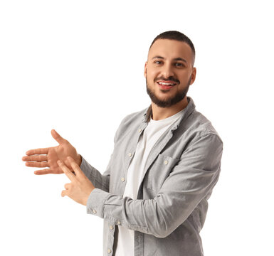 Young man using sign language on white background