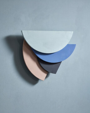Abstract Geometric Composition Featuring Layered Semi-Circle Shapes in Muted Pastel Tones on a Solid Soft Grey Background
