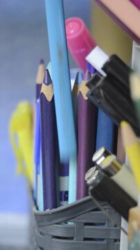 Close-up of a hand picking up a colored pencil