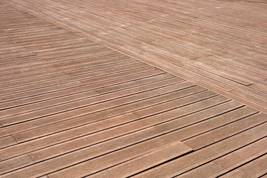Dark brown composite wooden deck flooring planks.