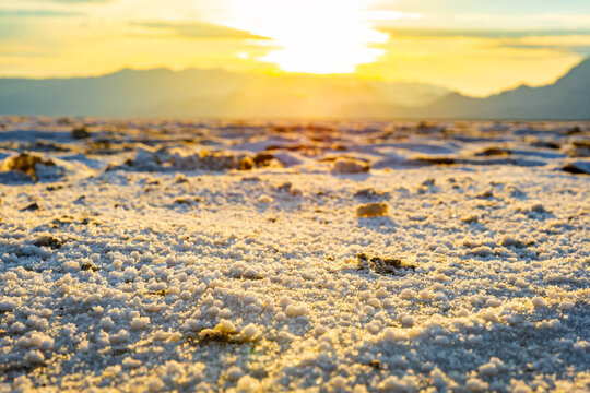 Golden sunrise illuminating textured crust at Bonneville Salt Flats Utah