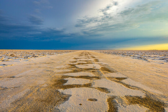 Race track trail across Bonneville Salt Flats at sunset