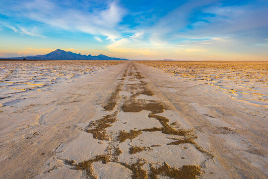 Race track trail across Bonneville Salt Flats at sunset