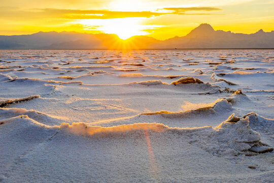 Golden sunset illuminating textured salt crust on Bonneville Flats