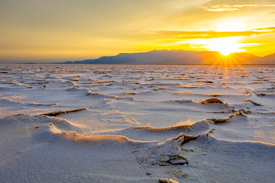 Golden sunset illuminating textured salt crust on Bonneville Flats