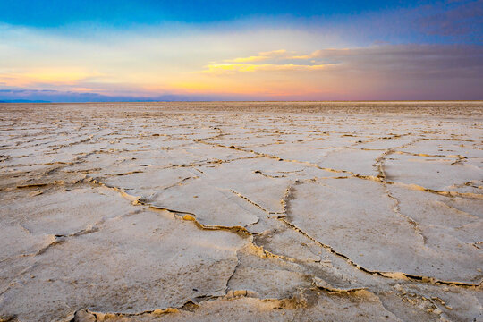 Golden sunset illuminating textured salt crust on Bonneville Flats