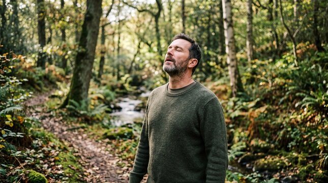 Serene Forest Escape: A man meditates amidst the tranquility of a sun-dappled forest, surrounded by verdant trees and the gentle murmur of a nearby stream.