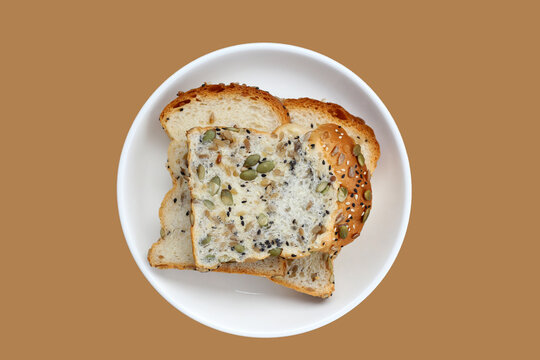 Sliced multigrain bread topped with pumpkin seeds, sunflower seeds, sesame, and black sesame.