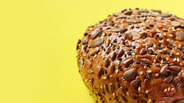 Healthy multigrain bread bun topped with mixed seeds and grains