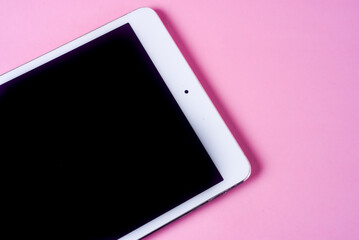 White Tablet with Blank Black Screen on Pink Background © julioandres
