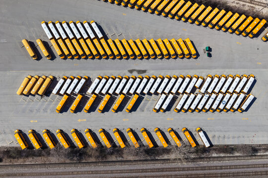 School buses parking in rows at lot aerial