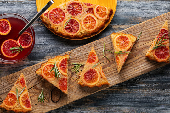 Homemade red orange upside down pie . Tropical dessert on green background. Top view