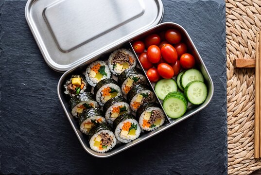Korean Gimbap Lunch Box with Fresh Cherry Tomatoes and Cucumber Slices in Stainless Steel Bento Container